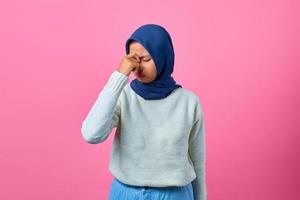 Portrait of young Asian woman looking dizzy and having headache photo