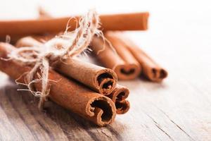 Cinnamon sticks on wood photo