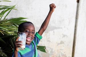 happy child holding a glass of milk. photo