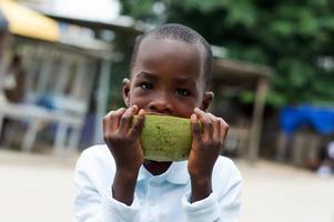 child with a watermelon on the street. photo