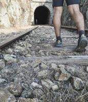 Man walking along the railroad tracks photo