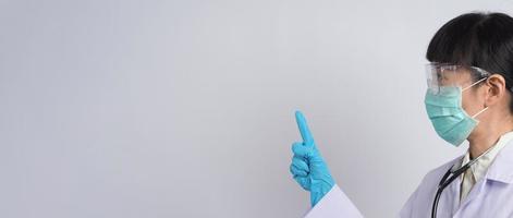 Doctor in uniform points to an empty area. Hand gesture. photo