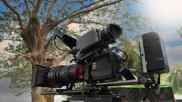 Behind the video camera that for recording movie at outdoor location.