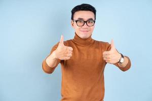 Asian man posing on blue background photo