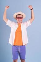 Portrait of young Asian man wearing summer clothing on blue background photo