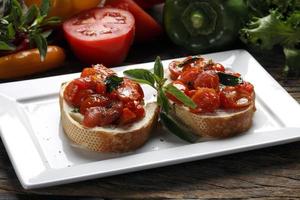 Bruschetta is an Italian antipasti made from bread, which is grilled with olive oil. photo