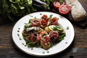 Dry tomato salad, bread and red wine photo