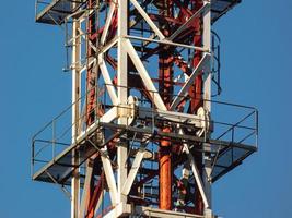 Levels on the platform of a tower crane with ladders and a railing. photo
