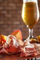 Cold platter with draft beer on a wooden cutting board photo