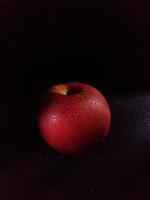 Close-up photo of fresh apples on a dark background