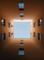 View from below looking up through buildings photo