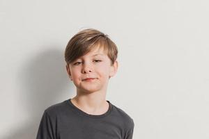 portrait of cute boy pulling faces, snooty look photo