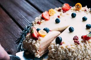 Cut peice white chocolate cake with berries photo