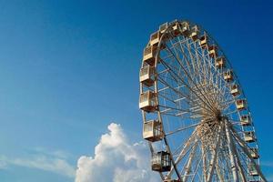 observation wheel against beautiful blue sky with clouds photo