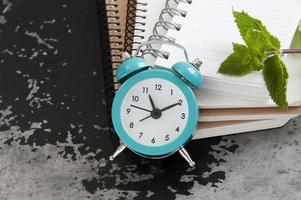 Turquoise alarm clock on black photo