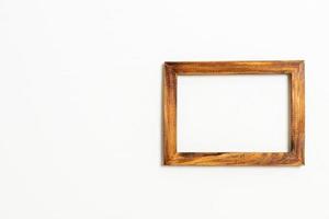 empty picture frame on white wall background photo