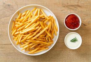 French fries with sour cream and ketchup photo