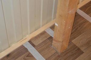 Installation of thresholds and baseboards in the interior of a residential building photo