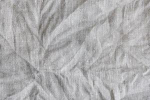 Gray textile linen tablecloth in full frame. photo