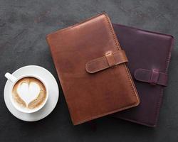 Leather notebooks and cup of coffee photo