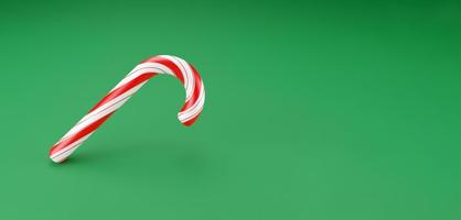 bastones de feliz navidad, caramelo de menta piruleta con rayas rojas sobre fondo verde. concepto de celebración de año nuevo. postre dulce tradicional. Render 3d foto