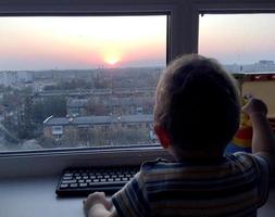 Beautiful baby boy with child face posing photographer near window photo