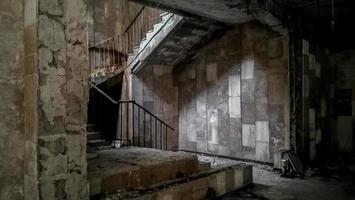 Pripyat, Ukraine, 2021 - Stone staircase inside an abandoned building in Chernobyl photo