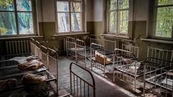 Pripyat, Ukraine, 2021 - Old orphanage beds in Chernobyl photo