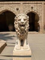 stone lion statue in front of the palace photo