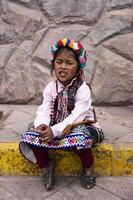 CUSCO, PERU, DECEMBER 31, 2017 - Unidentified girl on the street of Cusco, Peru. Almost 29 percent of Cusco population have less than 14 years. photo