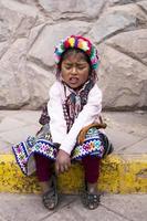 CUSCO, PERU, DECEMBER 31, 2017 - Unidentified girl on the street of Cusco, Peru. Almost 29 percent of Cusco population have less than 14 years. photo