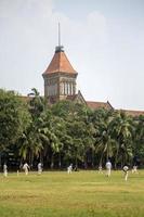 MUMBAI, INDIA, OCTOBER 10, 2015 - People playing cricket in the central park at Mumbai, India. Cricket is the most popular sport in India photo