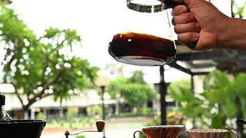 The barista is making coffee in a drip method for customers. video