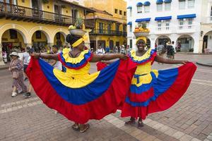 CARTAGENA, COLOMBIA, SEPTEMBER 16, 2019 - Unidentified palenquera, fruit seller lady on the street of Cartagena. These Afro-Colombian women come from village San Basilio de Palenque, outside the city. photo