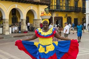 CARTAGENA, COLOMBIA, SEPTEMBER 16, 2019 - Unidentified palenquera, fruit seller lady on the street of Cartagena. These Afro-Colombian women come from village San Basilio de Palenque, outside the city.