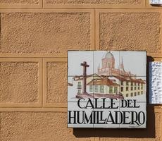 MADRID, SPAIN, MARCH 13, 2016 - Closeup of the street sign. Street signs in Madrid are hand-painted ceramic tiles typically composed within 9 or 12 tiles. They depict the name of the alley or street. photo