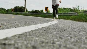 Woman running on the road trail in the morning video