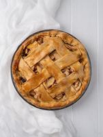 Top view of homemade apple pie on wooden table photo