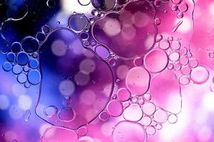 Blue and purple abstract pattern made with oil bubbles on water