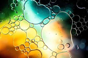 Black and gold abstract pattern made with oil bubbles on water photo