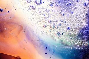 abstract background or texture with oil bubbles on water surface photo