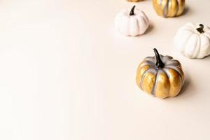 colorful painted pumpkins on white table with copy space photo