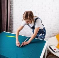 Woman tailor working with textile in her studio photo