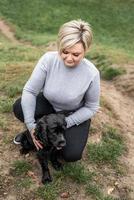 Black Cocker Spaniel with his owner in the park photo