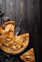 Top view of homemade apple pie on black wooden table photo