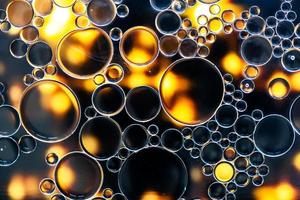 Black and golden bubbles on water surface photo