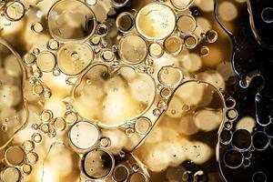 Black and gold abstract pattern made with oil bubbles on water photo