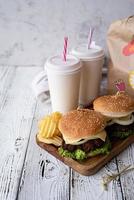 Conjunto de hamburguesas caseras, patatas fritas y bebida. foto