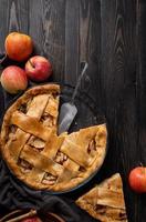 Top view of homemade apple pie on black wooden table photo