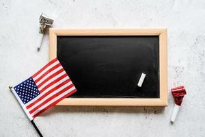 Closeup of American flag with a chalkboard with copy space for text